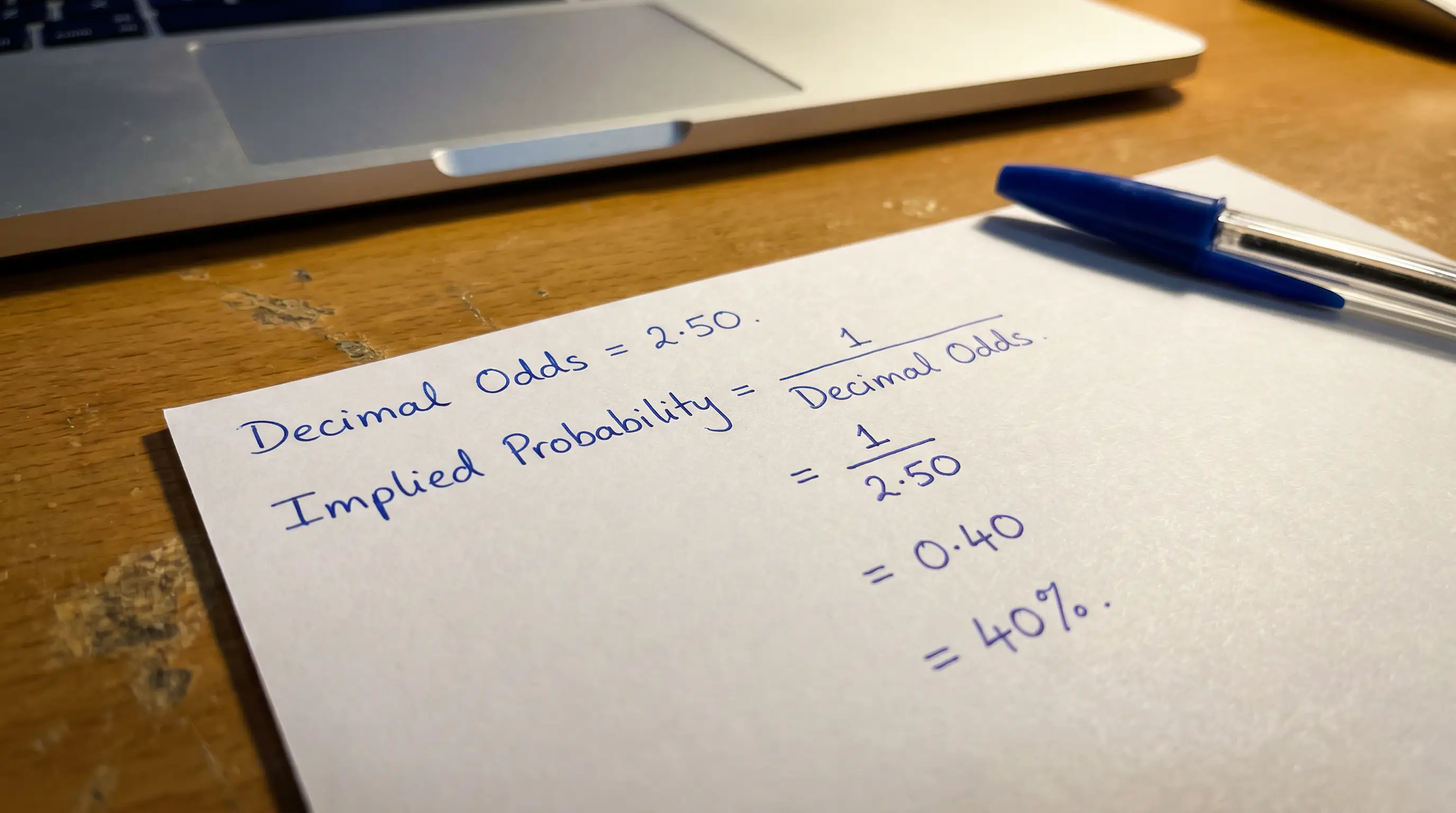Implied probability conversion from decimal odds written step by step on paper